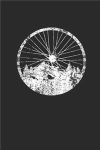 Bicycle Wheel With Mountain And Forest Silhouette