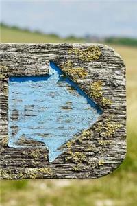 Blue Arrow on a Weathered Signpost Journal