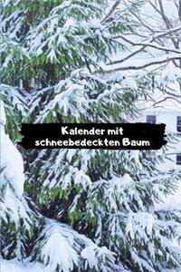 Kalender mit schneebedeckten Baum