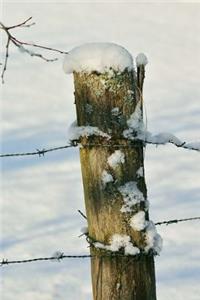 Barbed Wire Fence and Pole Covered in Snow Journal