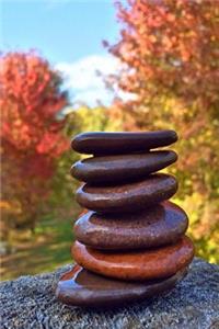 Zen Cairn Stack of Smooth Stones in the Fall Woods