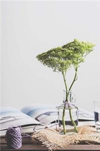 An Interior Still Life with Flowers, Thread, and a Book on a Table Journal