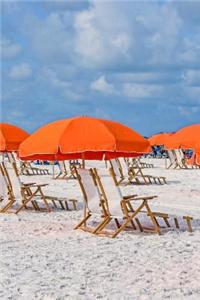 Beach Chairs and Orange Parasol Umbrella