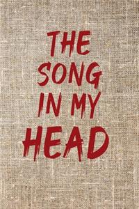 The Song in My Head Notebook with a background of tissu