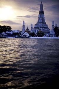 Prangs of Wat Arun and Chao Praya Rivert at Sunset in Bangkok Thailand