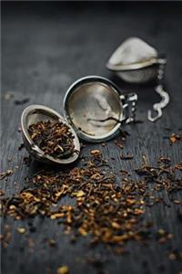 Dried Loose Tea Leaves and Silver Tea Strainer Journal