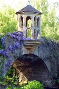 A Stone Bridge Draped with Purple Wisteria in a Formal Garden Journal