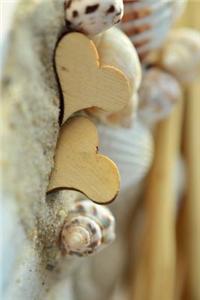 Wooden Hearts and Seashells in the Sand