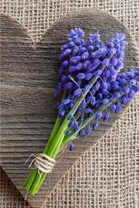 Grape Hyacinth Flowers on a Wooden Heart Journal