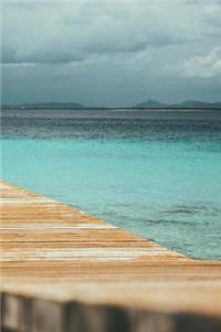 Stormy Skies over the Teal Ocean