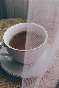 A Cup of Refreshing Peppermint Tea in a White Teacup Journal