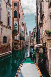 A Narrow Canal and Gondola on the Water in Venice, Italy Journal