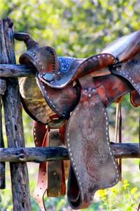 A Vintage Leather Saddle on a Corral Fence in Texas Journal