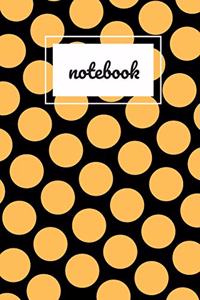 Black and orange polka dot print notebook