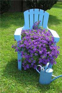 Lush Purple Flowers, a Blue Chair, and a Water Can in the Garden Journal