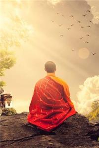 A Buddhist Monk in Saffron Robes Meditating in the Mountains Zen Journal