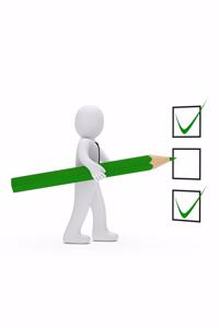 Man Ticking Off Checklist with a Pencil