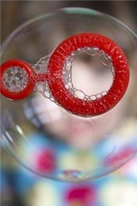 Blowing A Soap Bubble with a Red Wand Journal