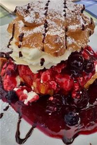 A Cream Puff Covered in Berries and Sauce, for the Love of Food