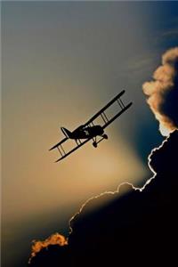 Biplane and Dramatic Clouds Aviation Journal
