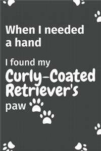 When I needed a hand, I found my Curly-Coated Retriever's paw