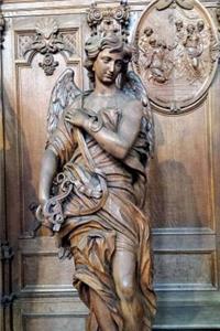 An Antique Wooden Angel Sculpture in a Church Journal