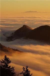 A Sunlit Golden Sea of Fog in the Mountains Journal