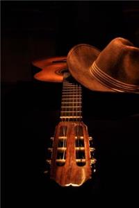 An Acoustic Guitar and a Brown Cowboy Hat Country and Western Music Journal
