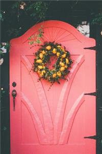 A Wreath with Yellow Flowers on a Pink Door Journal