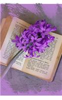 A Purple Hyacinth Flower on a Vintage Book Journal