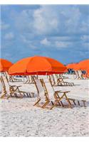 Beach Chairs and Orange Parasol Umbrella