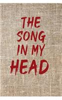 The Song in My Head Notebook with a background of tissu