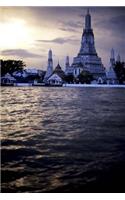 Prangs of Wat Arun and Chao Praya Rivert at Sunset in Bangkok Thailand