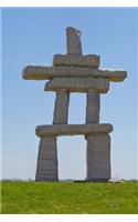Native Inukshuk on Grassy Hillside Journal: 150 page lined notebook/diary