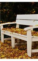 Park Bench in the Fall Covered in Leaves Journal