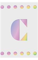 C: Modern minimalist monogram journal in soft pastel gradient colors. Have the initial letter of your name beautifully displayed on a fantasy-inspired 
