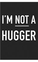 I'm Not a Hugger: A 6x9 Inch Matte Softcover Journal Notebook with 120 Blank Lined Pages and a Funny Cover Slogan