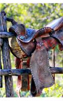 A Vintage Leather Saddle on a Corral Fence in Texas Journal: 150 Page Lined Notebook/Diary