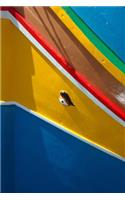A Close-Up Side View of a Colorful Boat in Malta Journal