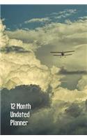 12 Month Undated Planner: 1 Year Daily Weekly Monthly Paperback Planner, Undated Start Anytime, Cover Has Cumulonimbus Clouds and Biplane