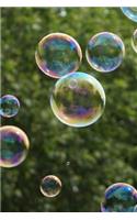 Blowing Soap Bubbles Highlighted Against Green Trees and a Blue Sky Journal: 150 Page Lined Notebook/Diary