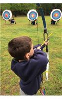 Determined Boy Practicing Archery Journal: 150 Page Lined Notebook/Diary