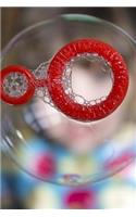 Blowing A Soap Bubble with a Red Wand Journal
