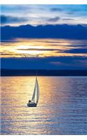 A Sailboat on the Water at Sunset Journal