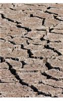 Dry Cracked Ground from a Drought in a Swamp Journal: 150 page lined notebook/diary